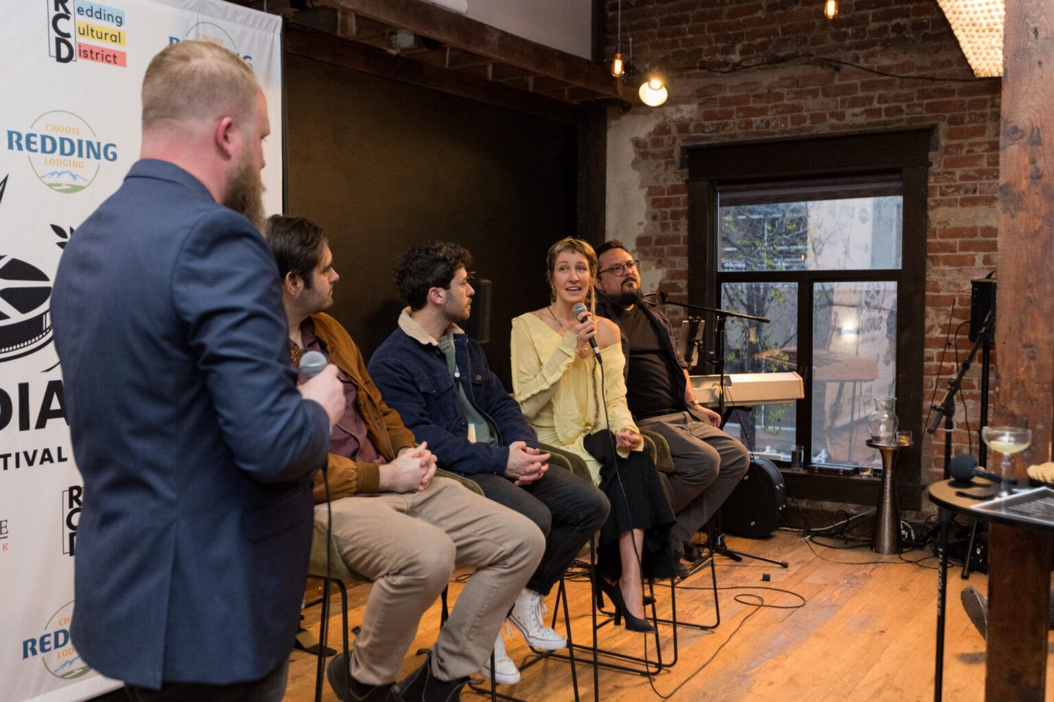 A panel of filmmakers answering questions during a community discussion